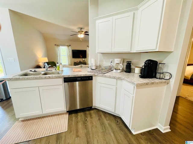 kitchen featuring kitchen peninsula, white cabinets, stainless steel dishwasher, and sink