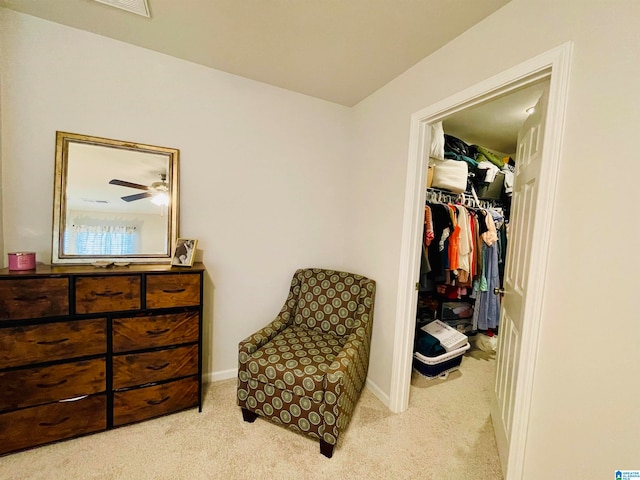 sitting room featuring light carpet and ceiling fan