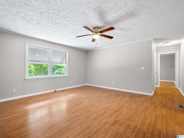 unfurnished room featuring ceiling fan, a textured ceiling, and light hardwood / wood-style flooring