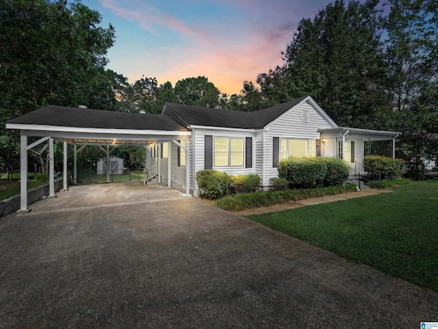 single story home with a yard and a carport