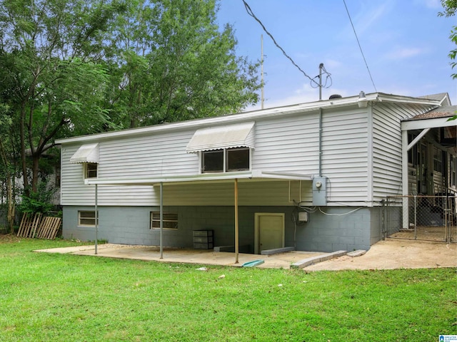 back of property with a patio and a lawn