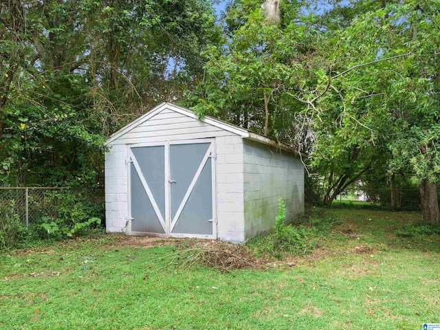 view of outdoor structure with a lawn