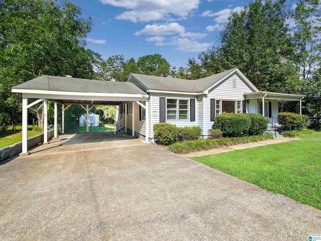 single story home featuring a carport and a front lawn