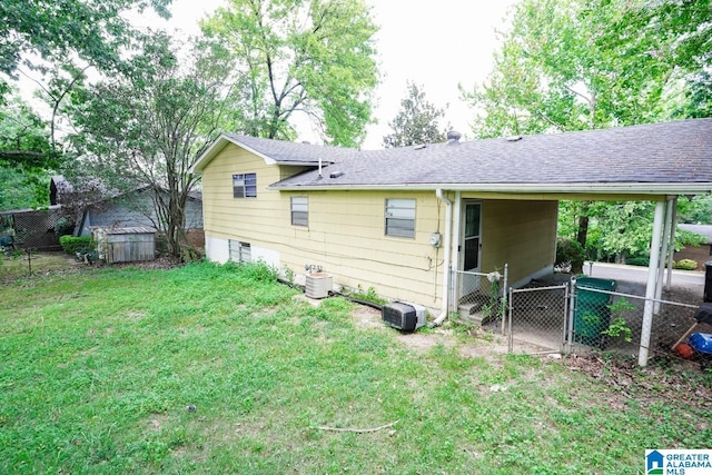 rear view of property with a lawn