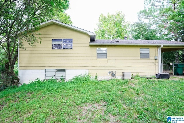 view of property exterior with a lawn