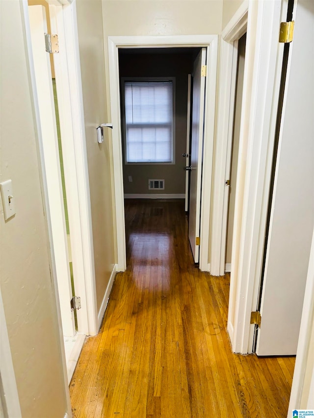 corridor featuring hardwood / wood-style floors