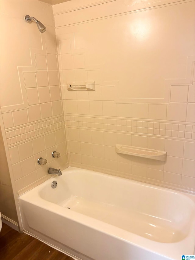 bathroom with wood-type flooring and tiled shower / bath combo