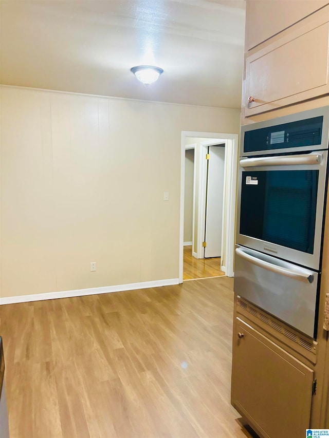 kitchen featuring light wood-type flooring and oven