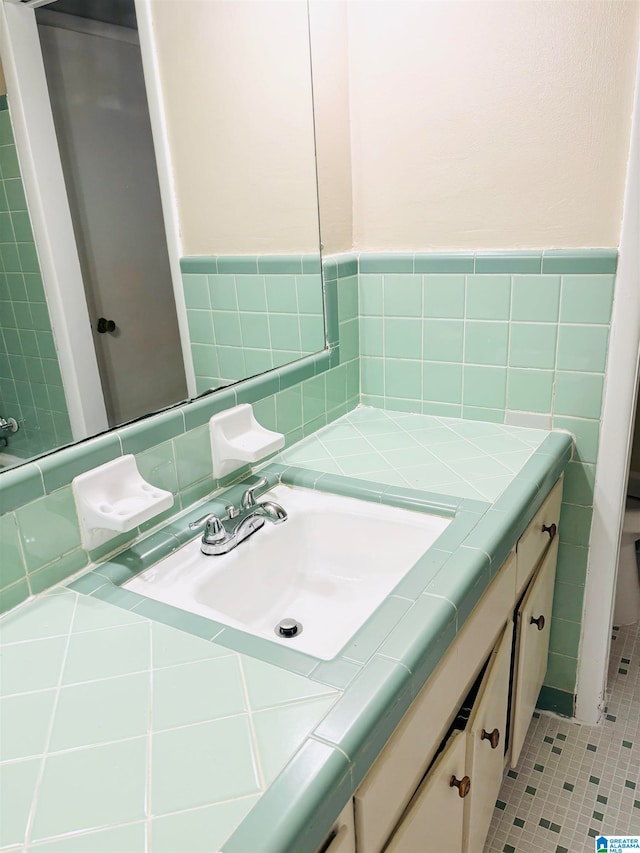 bathroom featuring tile patterned flooring and vanity