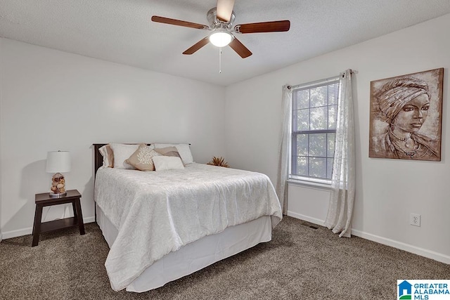 bedroom featuring ceiling fan and dark carpet