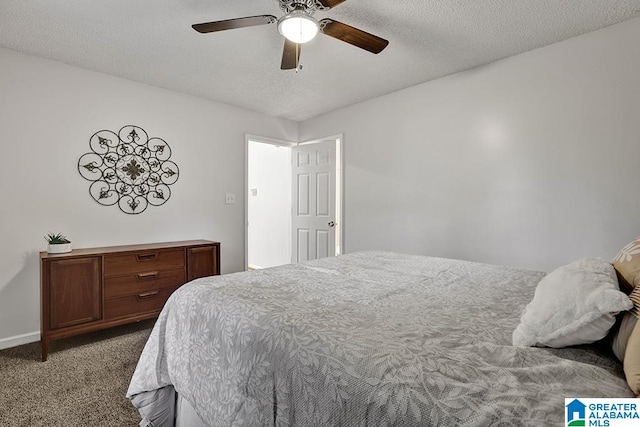 carpeted bedroom featuring ceiling fan and a textured ceiling