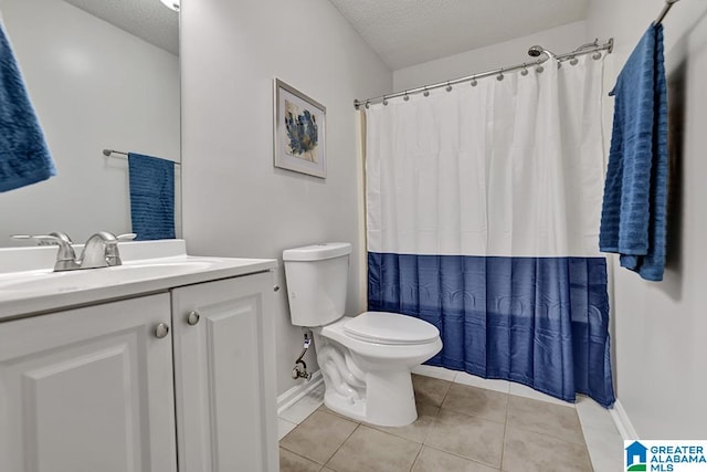 bathroom featuring tile patterned floors, toilet, a textured ceiling, and vanity