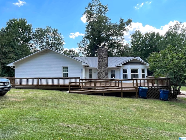 back of property with a deck and a lawn