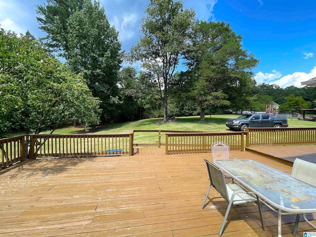 wooden deck featuring a yard