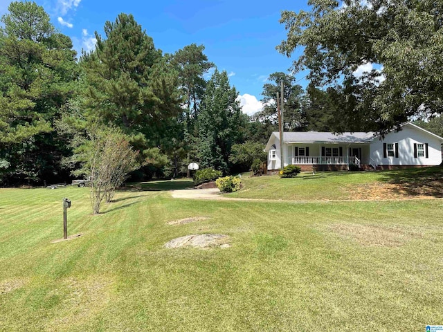 view of yard featuring covered porch