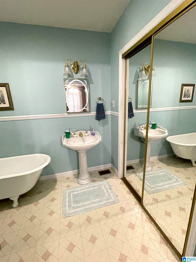 bathroom with a tub and tile patterned flooring