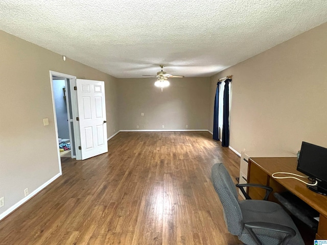 unfurnished office with ceiling fan, wood-type flooring, and a textured ceiling