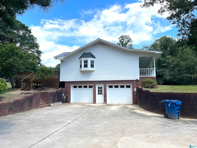 view of property exterior with a garage and a wooden deck