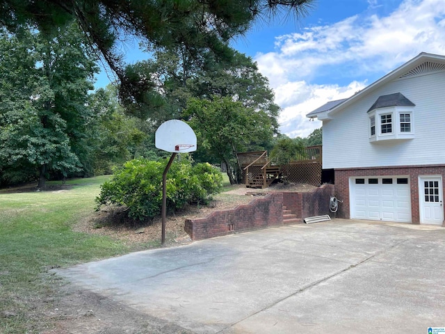 view of side of property with a lawn, a deck, and a garage