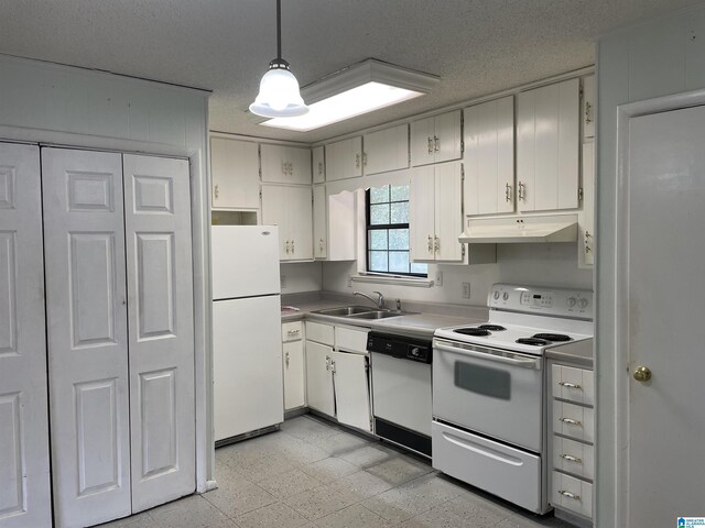 kitchen featuring white appliances, pendant lighting, light tile patterned flooring, and white cabinets