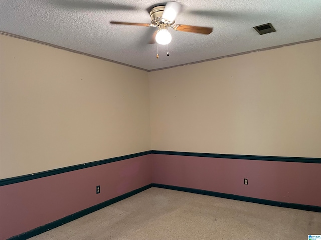 unfurnished room with ceiling fan and a textured ceiling