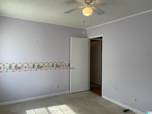 spare room with ceiling fan, carpet flooring, and a textured ceiling