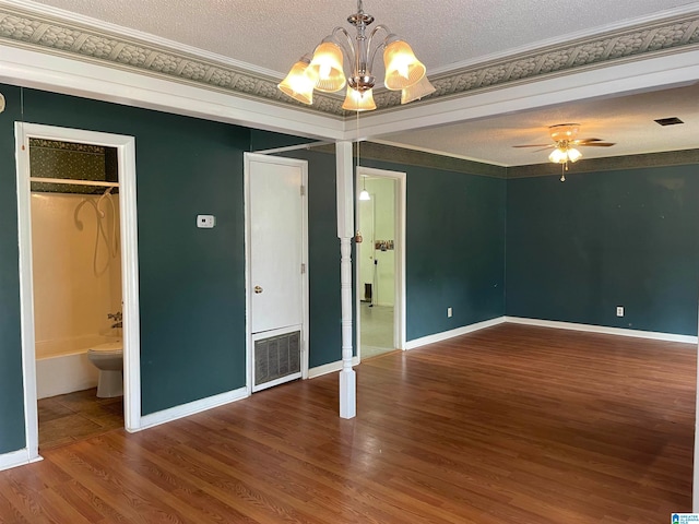 unfurnished room featuring hardwood / wood-style floors, ceiling fan with notable chandelier, crown molding, and a textured ceiling