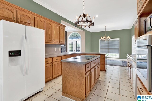 kitchen with a center island, white fridge with ice dispenser, black electric stovetop, decorative light fixtures, and oven