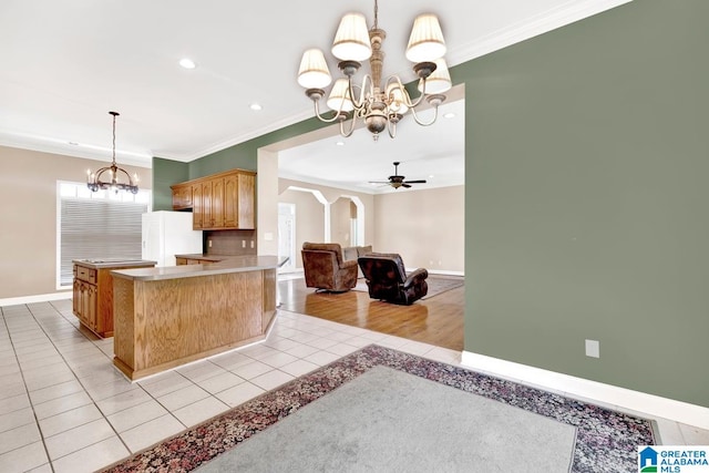 kitchen with white fridge, ceiling fan with notable chandelier, ornamental molding, and light wood-type flooring