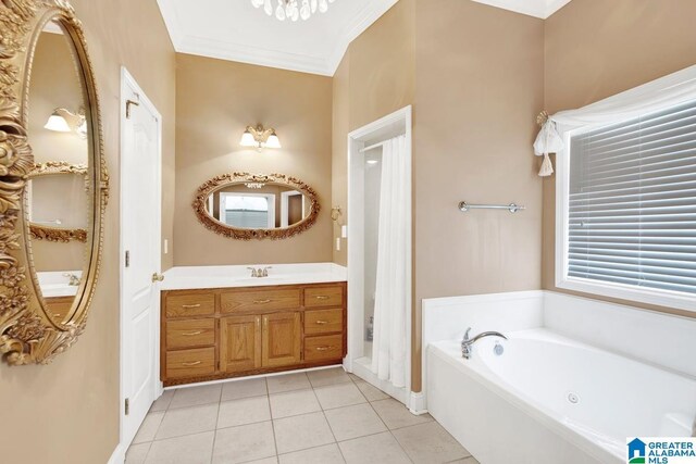 bathroom with tile patterned flooring, a washtub, vanity, and a healthy amount of sunlight