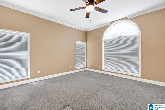 carpeted spare room with crown molding and ceiling fan