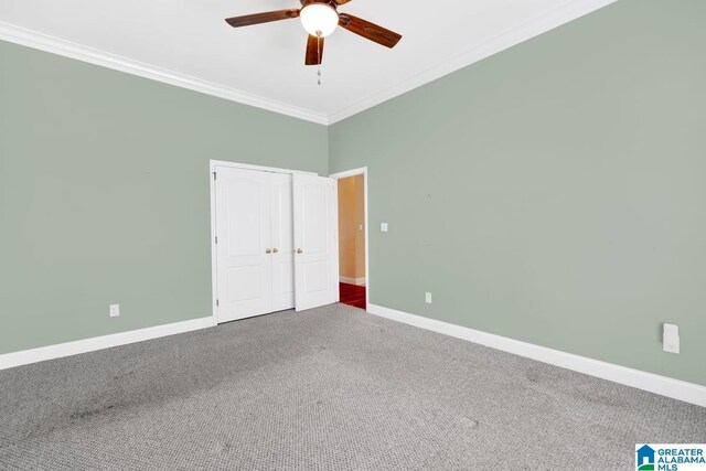 unfurnished room with carpet, crown molding, a high ceiling, and ceiling fan