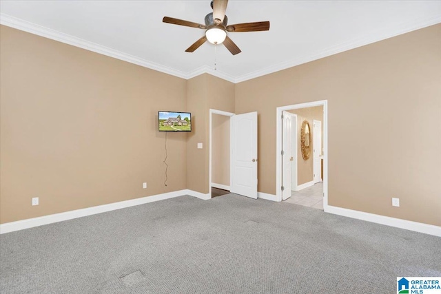 unfurnished bedroom featuring ensuite bath, ceiling fan, ornamental molding, and light carpet