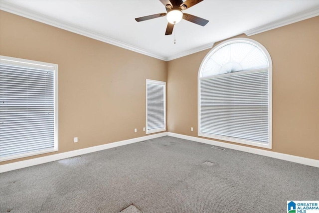 carpeted spare room featuring ornamental molding and ceiling fan