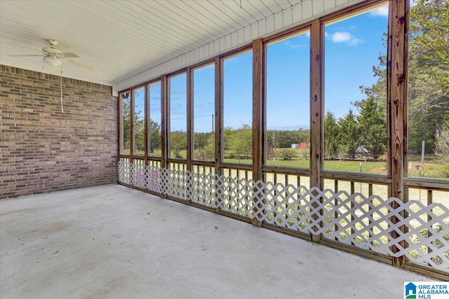 unfurnished sunroom featuring a wealth of natural light and ceiling fan