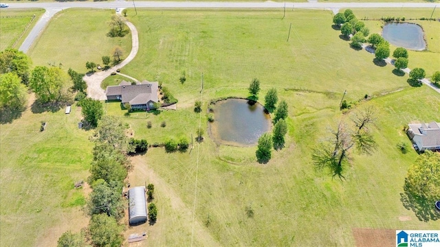 birds eye view of property with a water view and a rural view