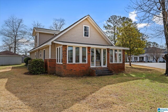 rear view of house featuring a yard