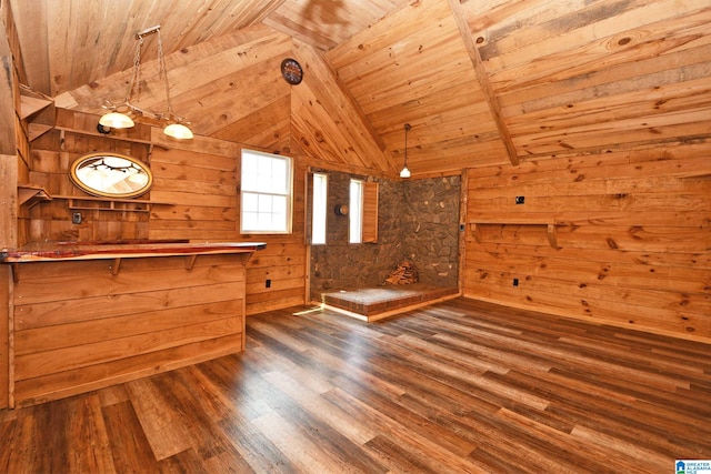 interior space with wood ceiling, wooden walls, hardwood / wood-style floors, and lofted ceiling with beams