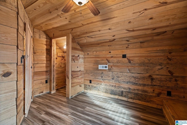 stairs with wooden walls, concrete floors, and wood ceiling