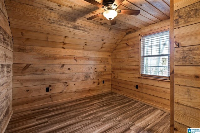 office space with light hardwood / wood-style floors, wooden walls, lofted ceiling, ceiling fan, and wooden ceiling