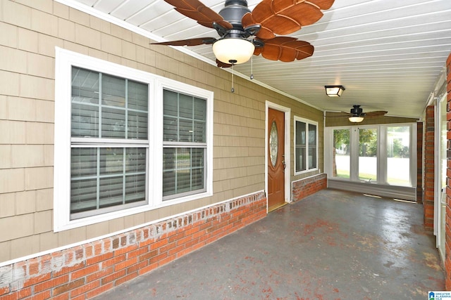 unfurnished sunroom with ceiling fan and lofted ceiling