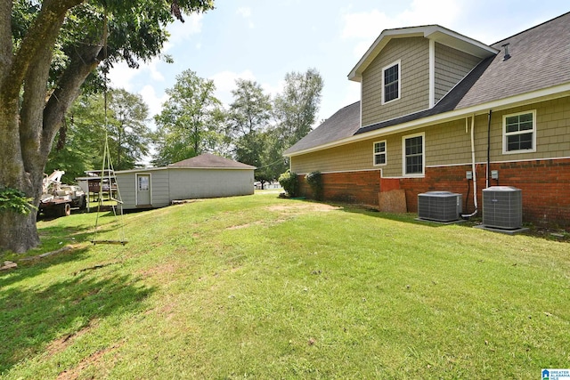 view of yard with central air condition unit and a storage shed