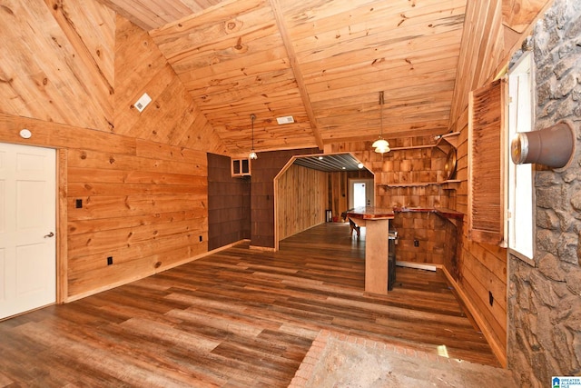 additional living space featuring wooden walls, lofted ceiling, hardwood / wood-style floors, and wood ceiling