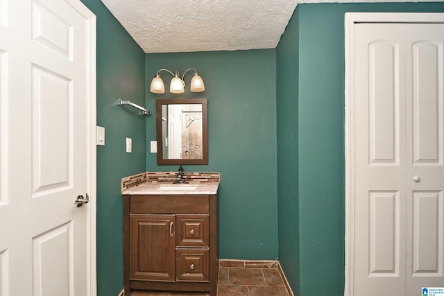 bathroom featuring tile patterned floors, a textured ceiling, and vanity