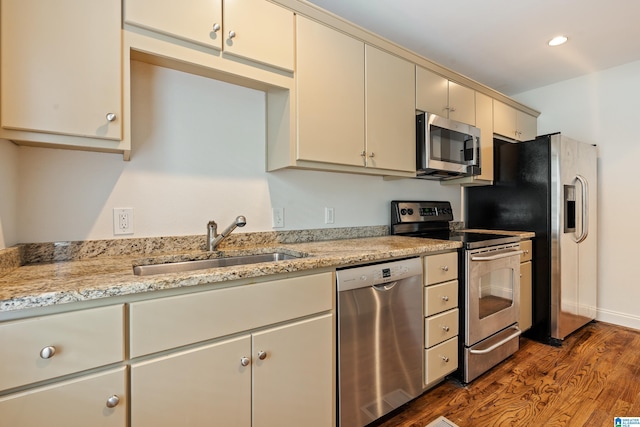 2701 11th Ave Unit 101, Birmingham, AL 35205 - kitchen featuring stainless steel appliances, a sink, wood finished floors, cream cabinets, and recessed lighting