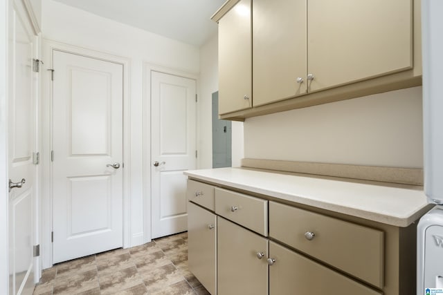 laundry room featuring cabinets and light tile patterned floors