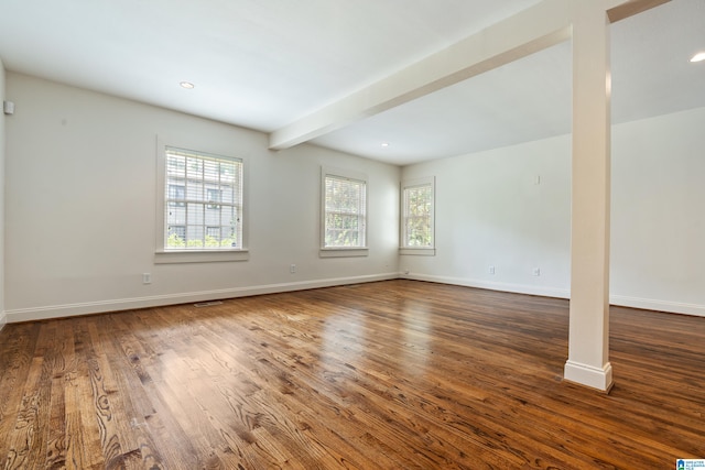 unfurnished room featuring beam ceiling and hardwood / wood-style flooring