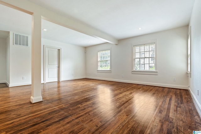 unfurnished room with beam ceiling and hardwood / wood-style flooring