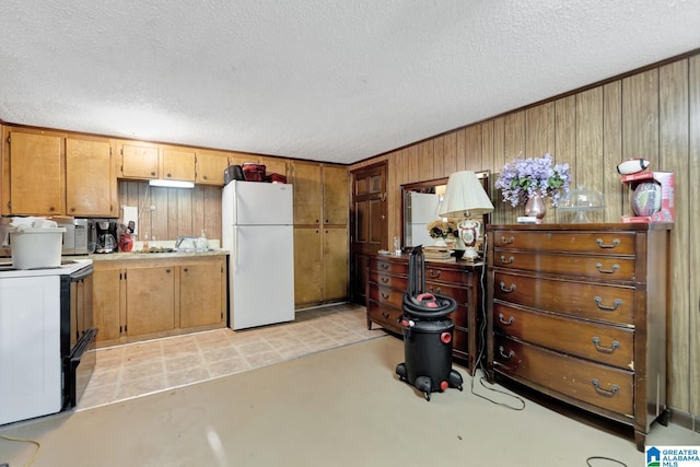 kitchen with a textured ceiling and white appliances