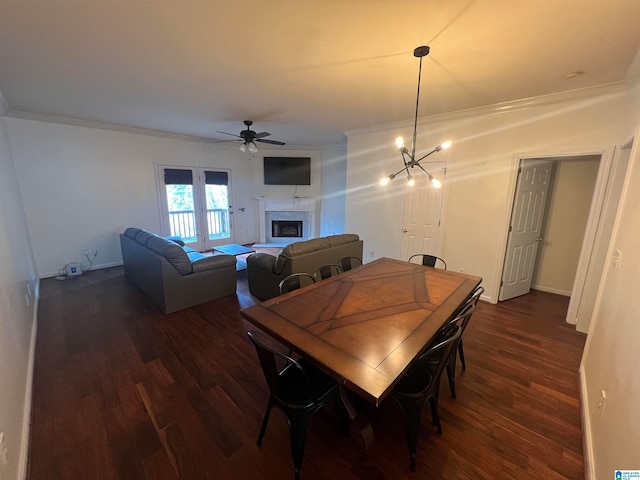 dining room featuring ornamental molding, ceiling fan with notable chandelier, and dark hardwood / wood-style flooring